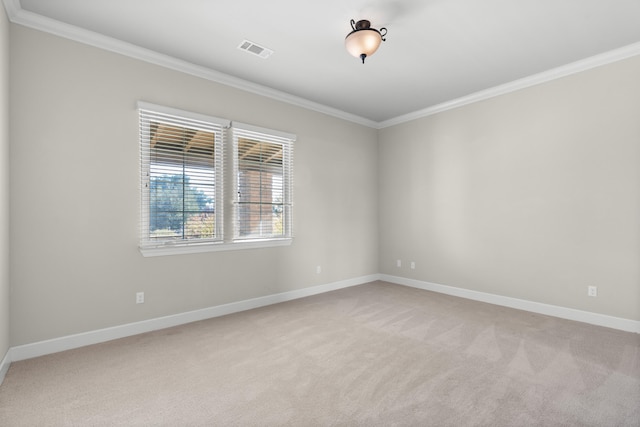 empty room with light colored carpet and ornamental molding