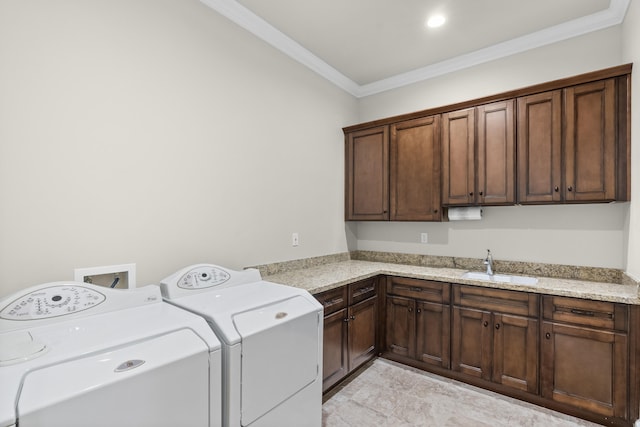 clothes washing area featuring sink, cabinets, independent washer and dryer, and ornamental molding