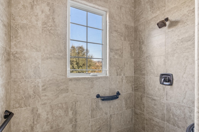 bathroom with a tile shower