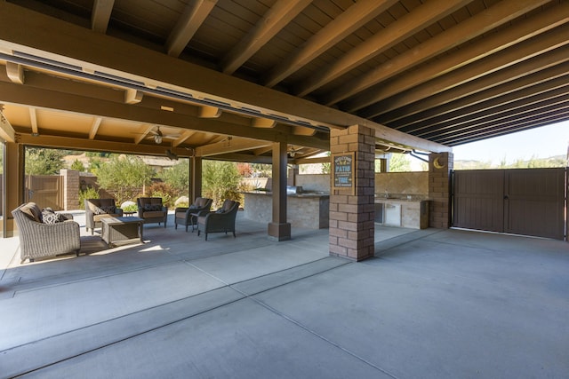 view of patio featuring an outdoor kitchen, ceiling fan, and an outdoor hangout area