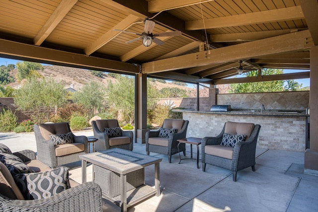 view of patio / terrace with outdoor lounge area, an outdoor kitchen, ceiling fan, and a gazebo