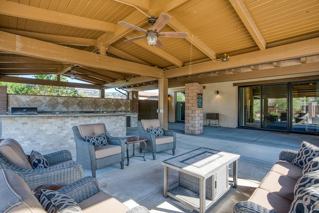 view of patio with ceiling fan, outdoor lounge area, and exterior kitchen