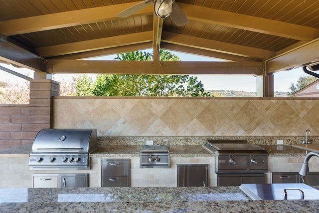 view of patio featuring a grill, a gazebo, and exterior kitchen