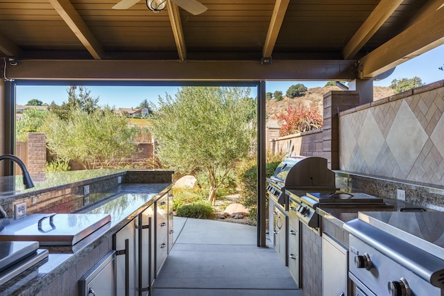 view of patio featuring area for grilling and ceiling fan