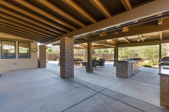 view of patio / terrace featuring exterior bar, exterior kitchen, and ceiling fan