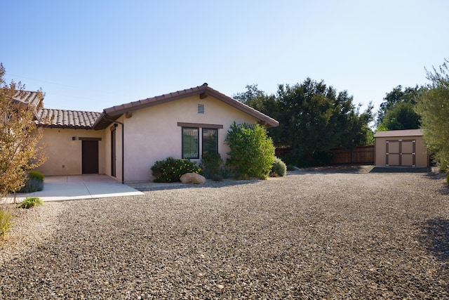 exterior space with a storage unit and a patio