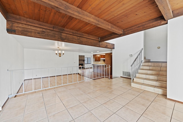 interior space featuring light tile patterned floors, visible vents, stairs, beam ceiling, and an inviting chandelier