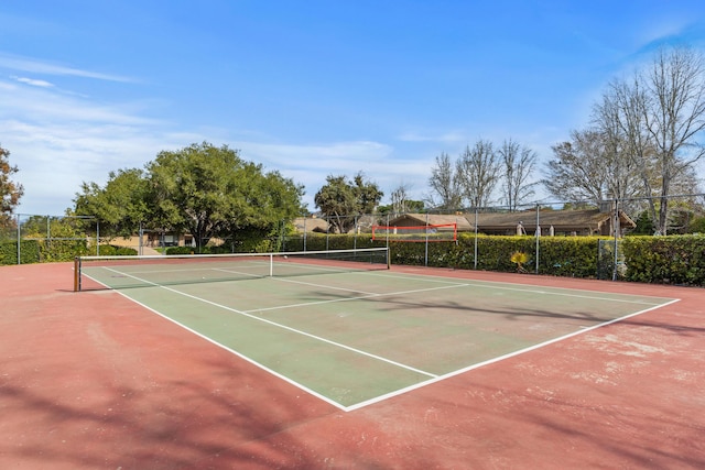 view of tennis court with fence