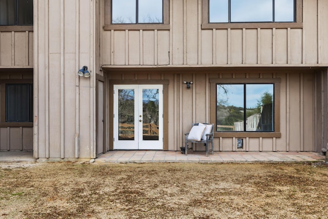 entrance to property featuring board and batten siding and french doors