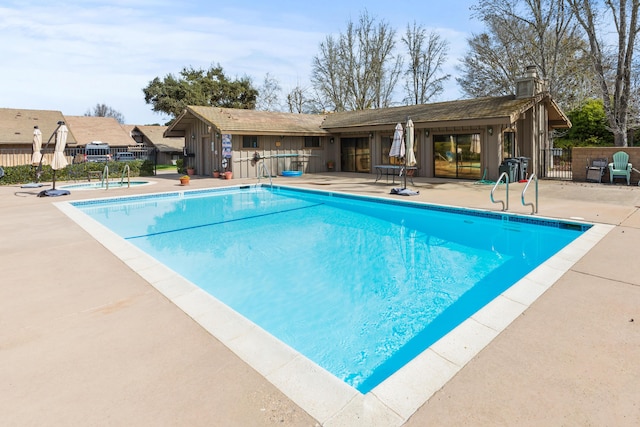 pool with fence and a patio