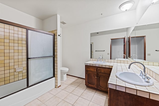 bathroom featuring double vanity, visible vents, a sink, and bath / shower combo with glass door