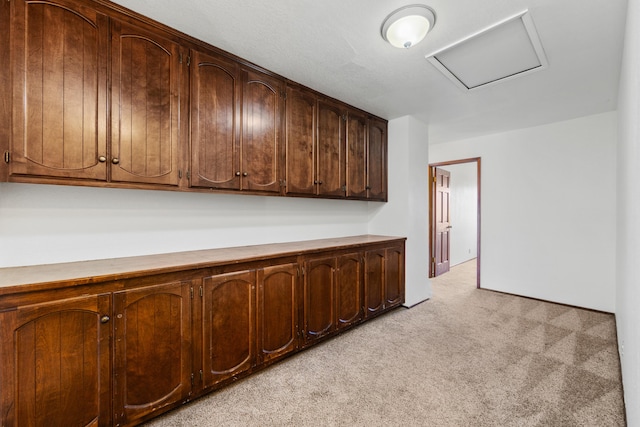 kitchen with light countertops and light colored carpet