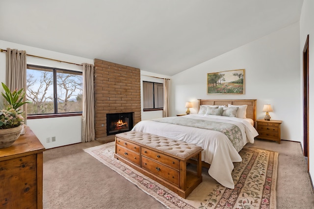 bedroom featuring lofted ceiling, a brick fireplace, baseboards, and light colored carpet