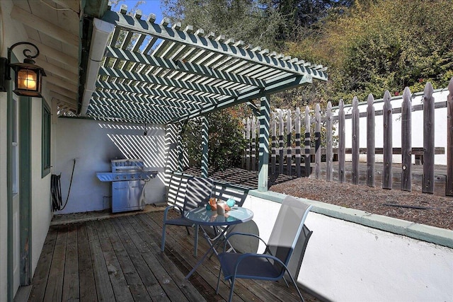 wooden deck with a pergola, a grill, and fence