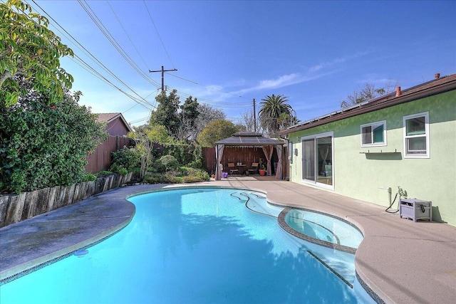 view of pool with a fenced backyard, a pool with connected hot tub, a patio, and a gazebo