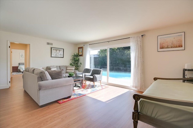 living room featuring light wood-type flooring and visible vents