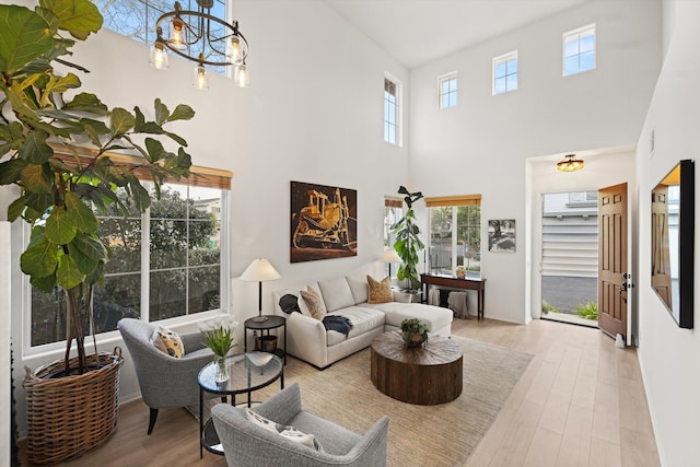 living room with a chandelier and wood finished floors