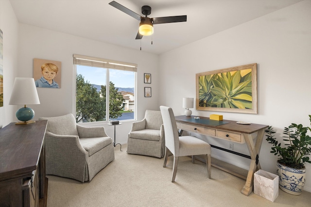 carpeted office space featuring a ceiling fan