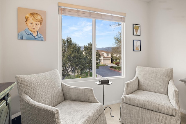 living area with carpet floors and baseboards