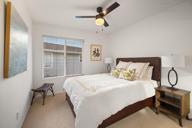 bedroom with baseboards, a ceiling fan, and light colored carpet