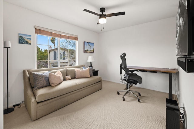 home office with a ceiling fan and carpet