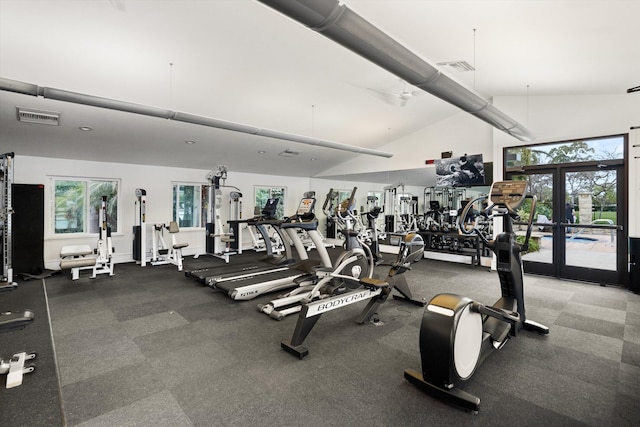 exercise room featuring high vaulted ceiling, visible vents, a wealth of natural light, and french doors