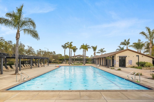 community pool with a pergola and a patio