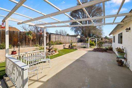 view of patio with fence and a pergola