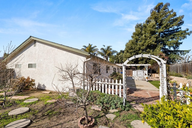 view of home's exterior featuring fence and stucco siding