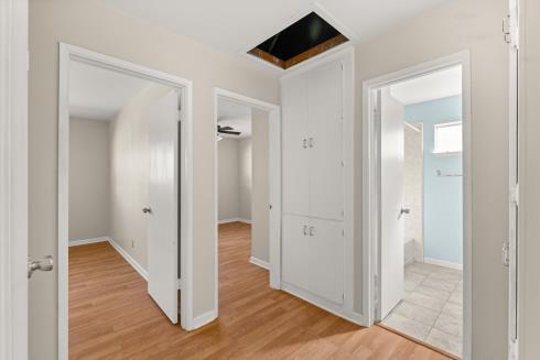 hall with baseboards and light wood finished floors