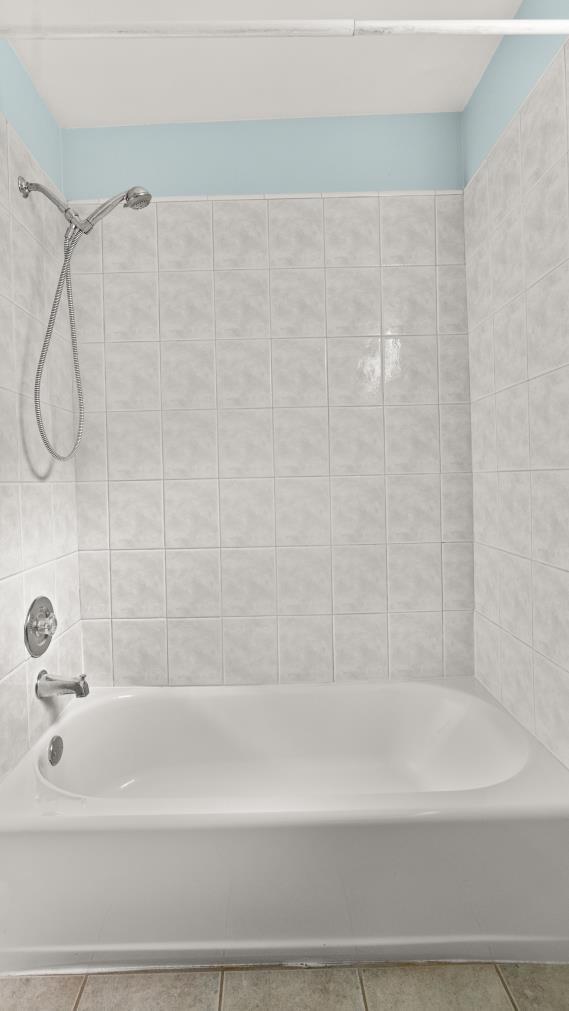 full bath featuring shower / tub combination and tile patterned floors