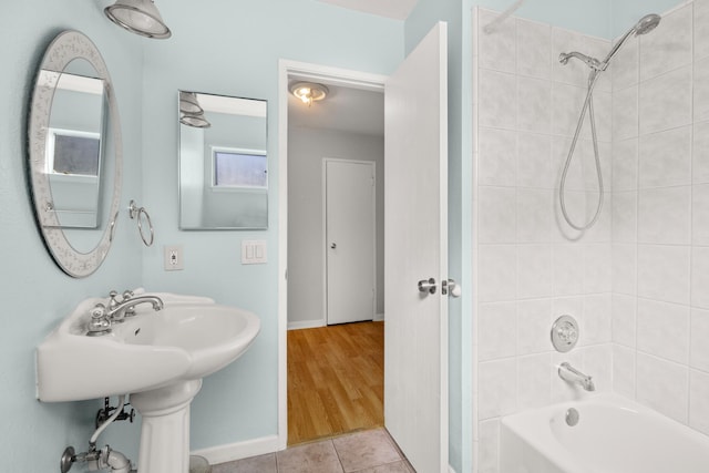 full bathroom with baseboards, shower / washtub combination, and tile patterned floors