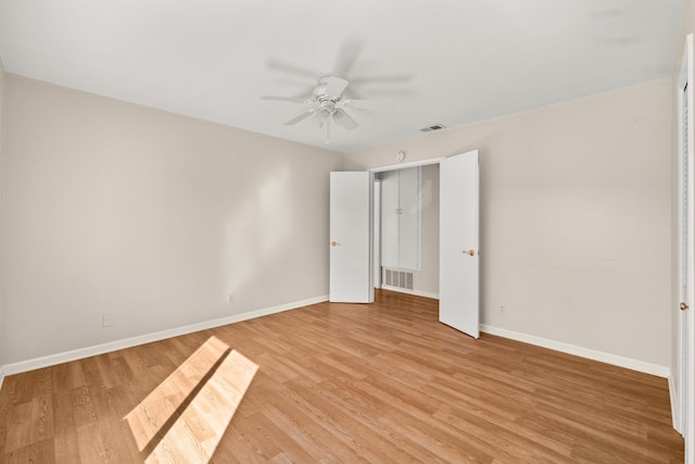 unfurnished bedroom with light wood finished floors, visible vents, and baseboards