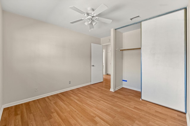 unfurnished bedroom featuring light wood finished floors, a closet, visible vents, and baseboards