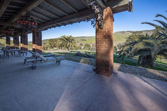 view of patio / terrace with a mountain view