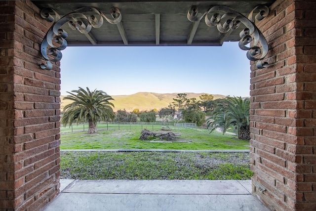 view of yard featuring fence and a mountain view