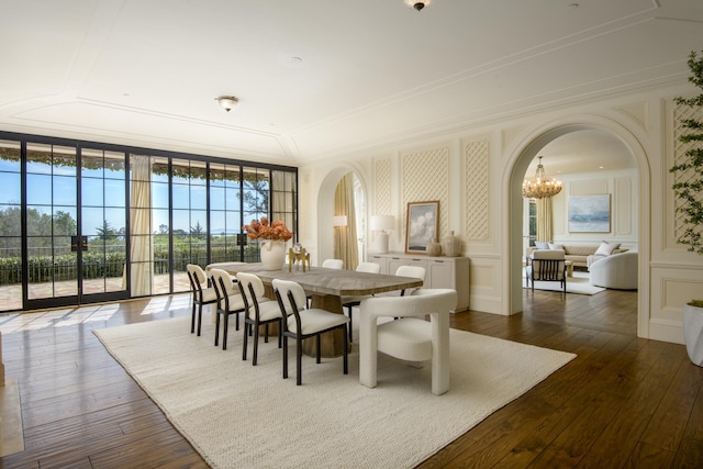 771 Garden Ln, Montecito, CA 93108 - dining space with arched walkways, dark wood-style floors, and a decorative wall