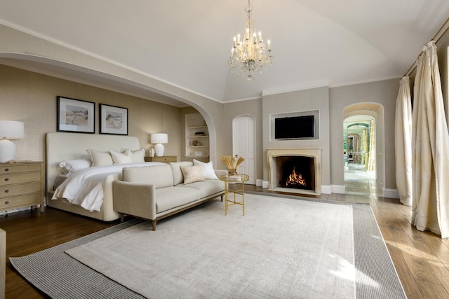 771 Garden Ln, Montecito, CA 93108 - bedroom with baseboards, a fireplace with flush hearth, arched walkways, and wood finished floors