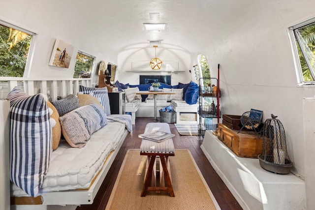 living room with dark wood-style floors and vaulted ceiling