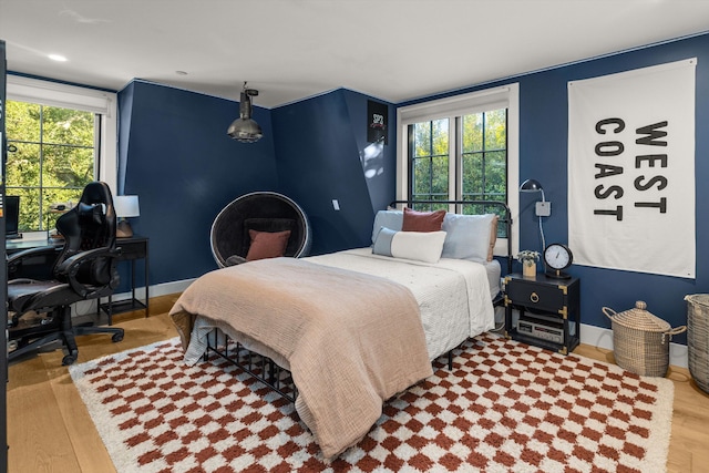 bedroom with baseboards and wood finished floors