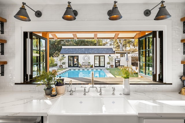 view of swimming pool featuring a sink