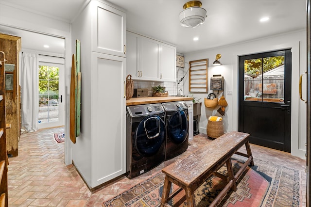 laundry room with brick floor, recessed lighting, and separate washer and dryer