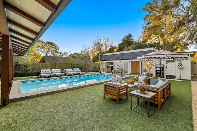 view of pool with an outbuilding, an exterior structure, a fenced in pool, and fence