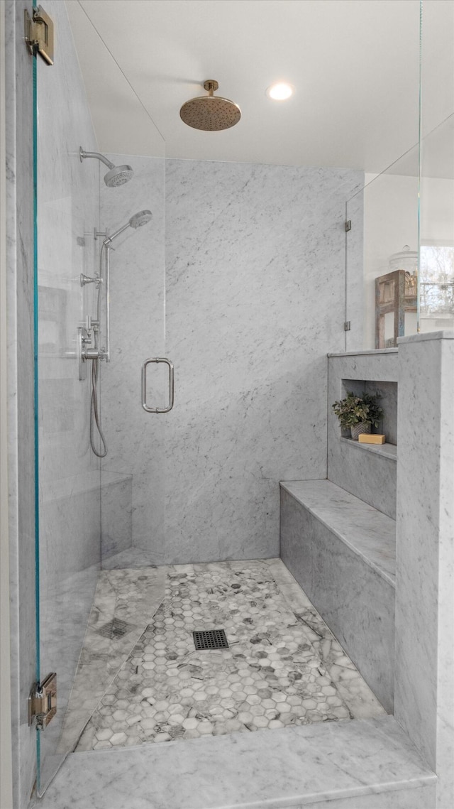 full bath featuring a marble finish shower