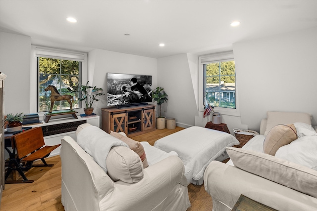 living area with light wood-style floors and recessed lighting