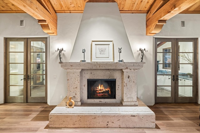 details featuring wooden ceiling, a premium fireplace, wood finished floors, french doors, and beamed ceiling