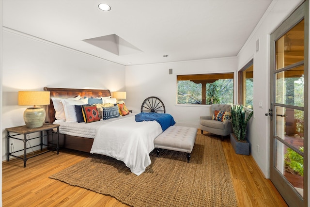 bedroom featuring multiple windows, wood finished floors, and recessed lighting