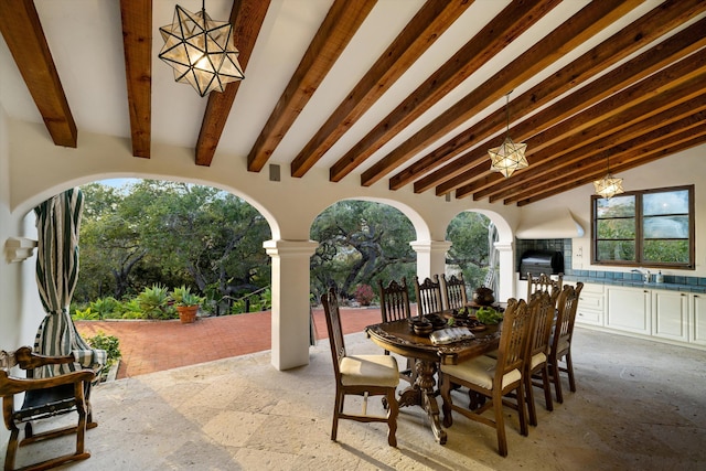 view of patio / terrace featuring an outdoor kitchen, outdoor dining area, a sink, and area for grilling