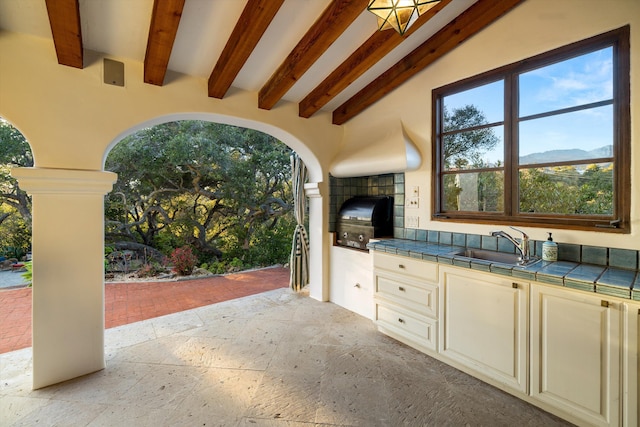 view of patio with a sink, a grill, and exterior kitchen