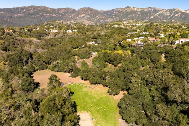 birds eye view of property featuring a mountain view and a view of trees